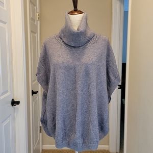 Women's drop shoulder sleeveless sweater with button up side.